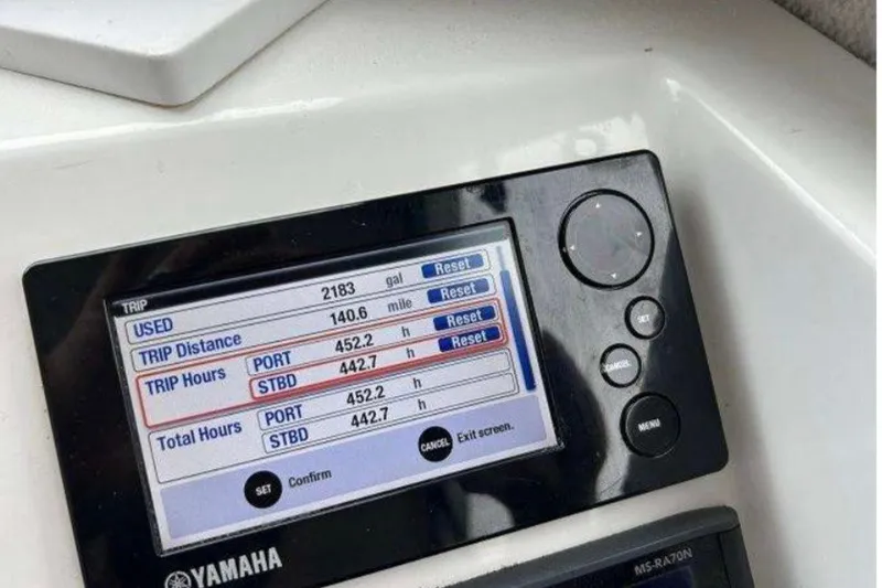 Slide: The Image of Boat dashboard display showing trip data and hours for Yamaha engine. - 14