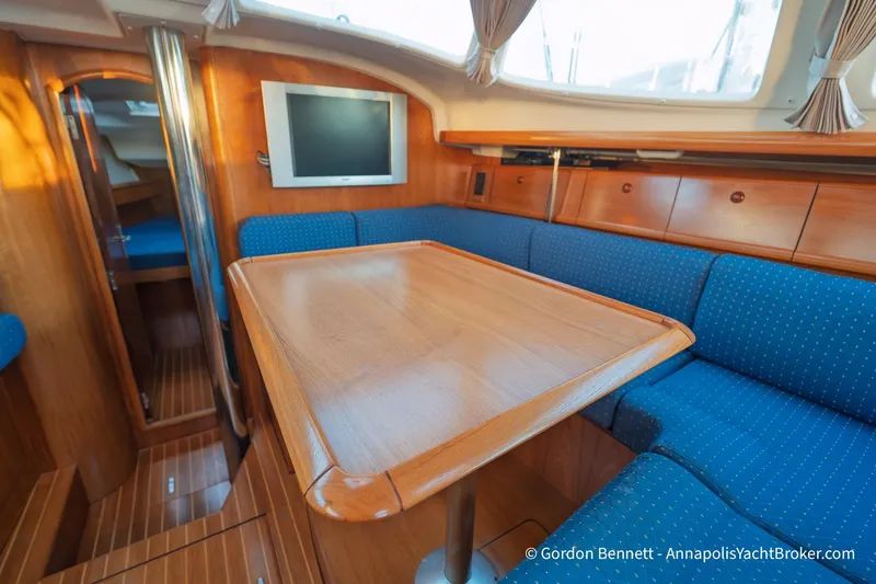 Slide: The Image of Interior of 2004 Jeanneau Sun Odyssey 43 DS yacht with wooden table and blue seating. - 40