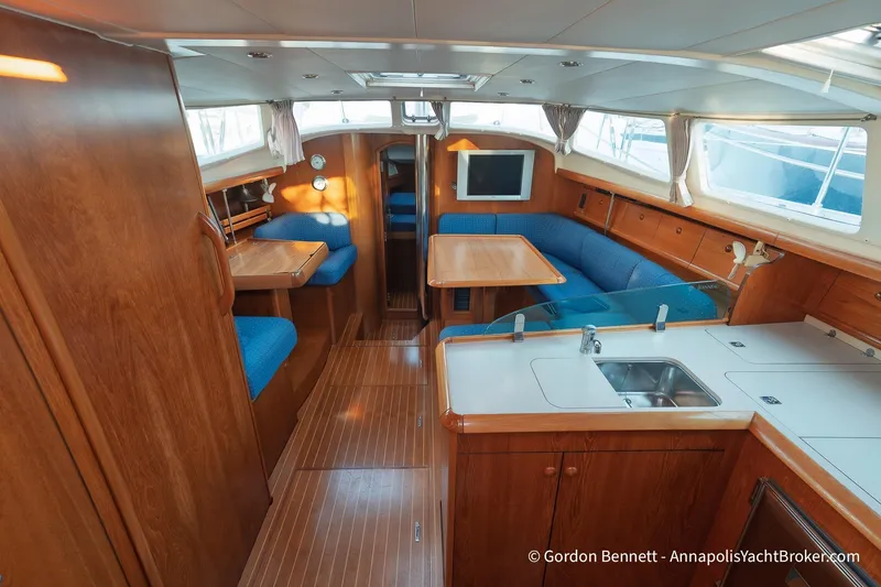 Slide: The Image of Interior of 2004 Jeanneau Sun Odyssey 43 DS yacht with wood finish and blue seating. - 31