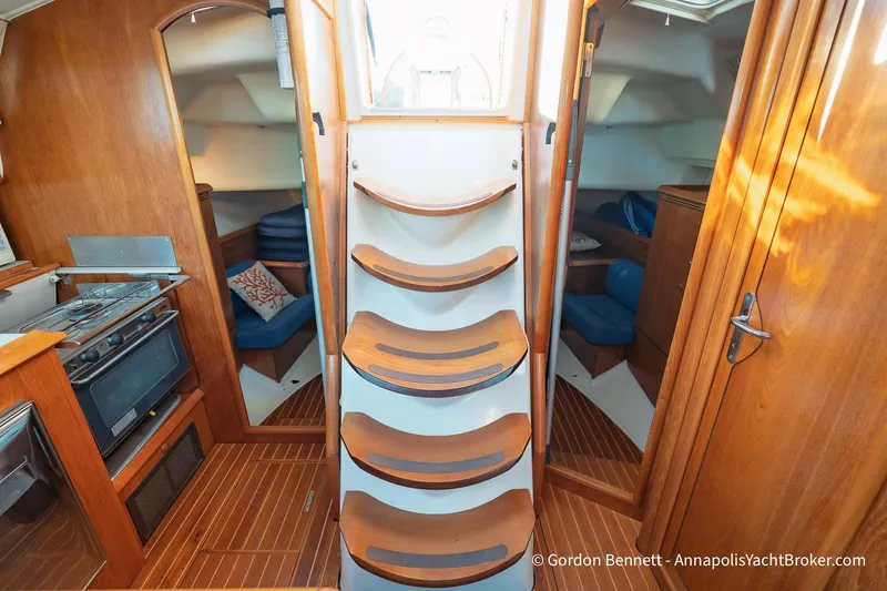 Slide: The Image of Interior of 2004 Jeanneau Sun Odyssey 43 DS sailboat with wooden stairs and cozy cabin. - 32
