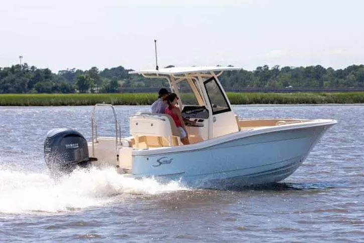 Slide: The Image of Manufacturer Provided Image: 2025 Scout 240 XSF boat cruising on a lake with two passengers. - 3