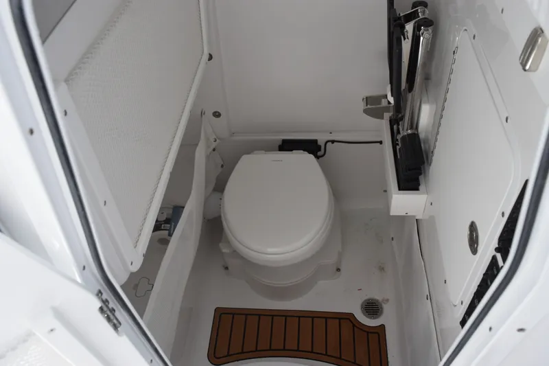 Slide: The Image of Interior of 2027 Sea Hunt Gamefish 27FS boat bathroom with toilet and storage. - 15