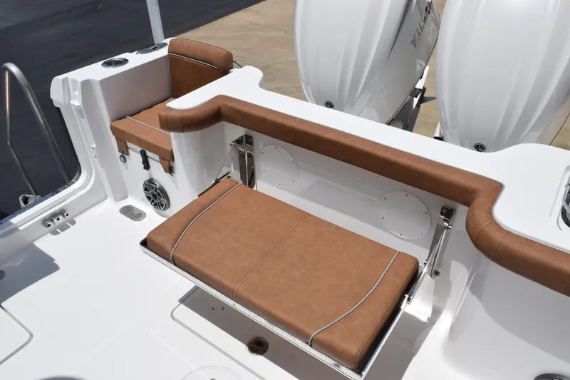 Slide: The Image of 2027 Sea Hunt Gamefish 27FS boat with brown cushioned seating and dual outboard motors. - 24