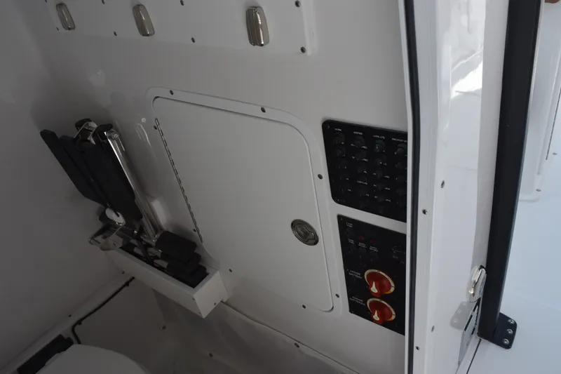 Slide: The Image of 2027 Sea Hunt Gamefish 27FS boat interior with control panel and storage compartment. - 17