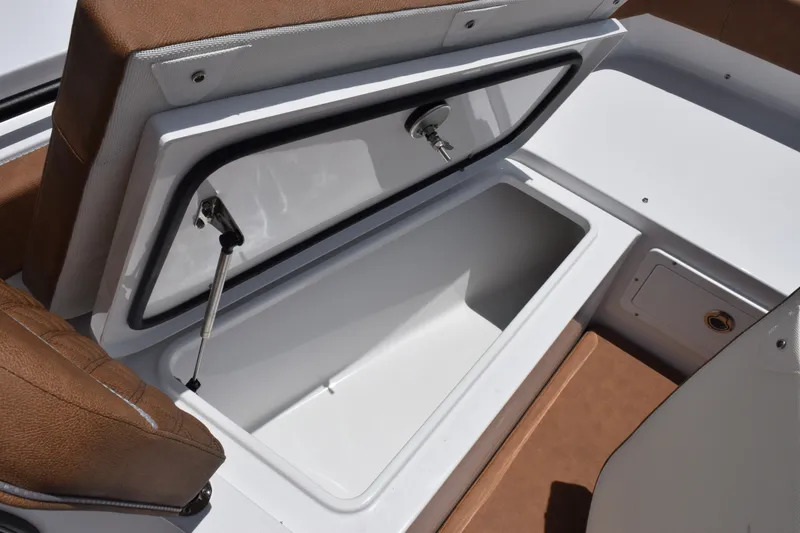 Slide: The Image of Open storage compartment on 2027 Sea Hunt Gamefish 27FS boat with brown seating. - 18