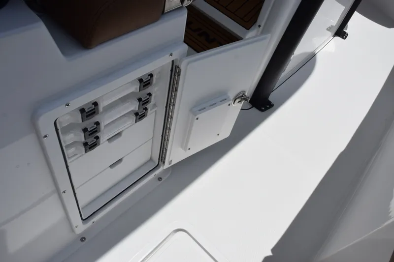 Slide: The Image of Open storage compartment on 2027 Sea Hunt Gamefish 27FS boat, showcasing organized interior. - 26