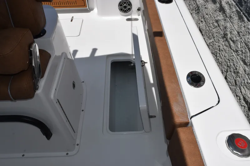 Slide: The Image of Interior view of 2027 Sea Hunt Gamefish 27FS boat, featuring seating and storage compartment. - 19