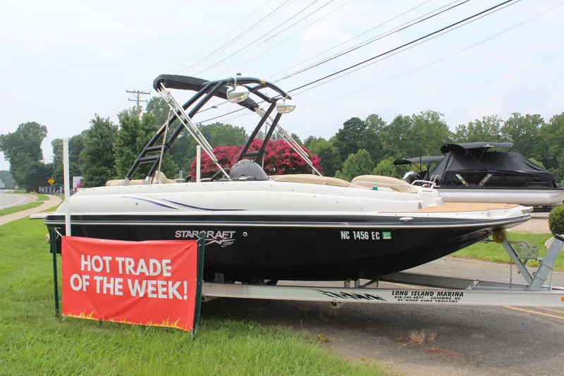 The Image of 2015 Starcraft Star Step 220 I/O boat on trailer, "Hot Trade of the Week" sign. - 7
