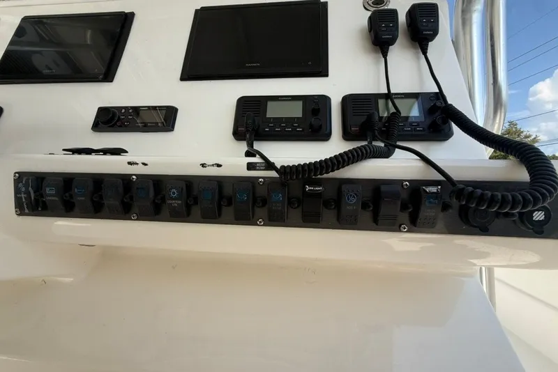 Slide: The Image of 2018 Twin Vee 36 Center Console dashboard with electronic controls and communication devices. - 23
