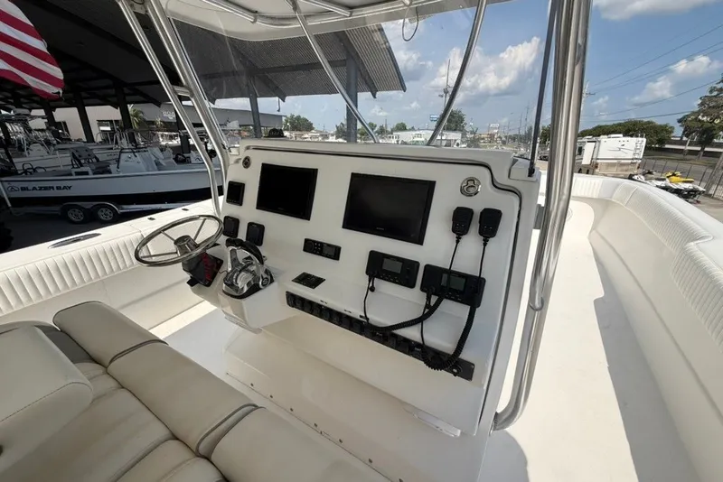 Slide: The Image of 2018 Twin Vee 36 Center Console boat dashboard with steering wheel and electronic controls. - 21