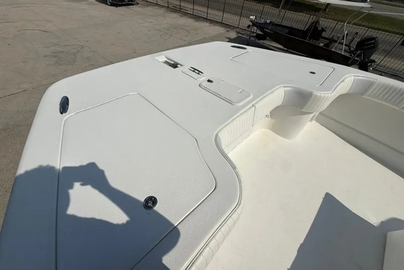 Slide: The Image of 2018 Twin Vee 36 Center Console boat deck, featuring spacious seating and storage compartments. - 32