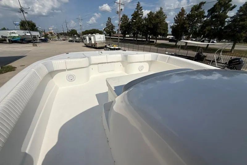 Slide: The Image of 2018 Twin Vee 36 Center Console boat with spacious deck, parked outdoors under a clear sky. - 27