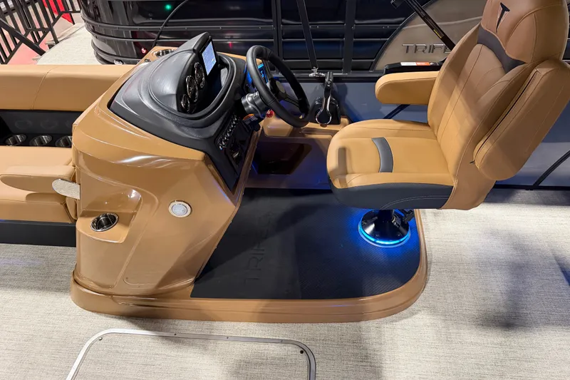 Slide: The Image of Captain's seat and helm of 2027 Trifecta 24 ULCS 3.0 pontoon boat, featuring modern controls. - 16