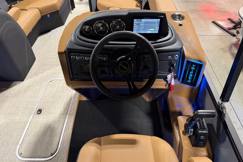 Slide: The Image of 2027 Trifecta 24 ULCS 3.0 boat dashboard with steering wheel and digital controls. - 17