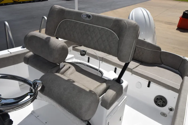 Slide: The Image of 2027 Sea Hunt Ultra 229 boat interior with cushioned seating and steering wheel. - 15