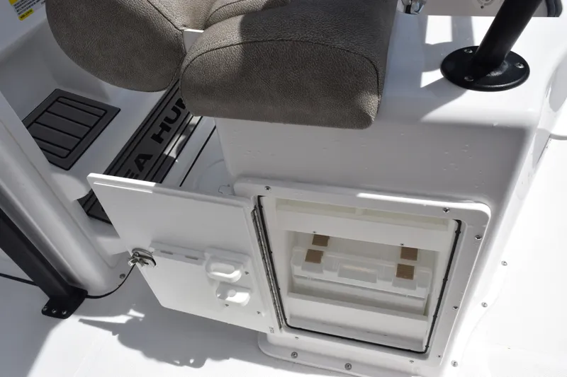 Slide: The Image of Interior view of a 2027 Sea Hunt Ultra 229 boat, featuring seating and storage compartment. - 17