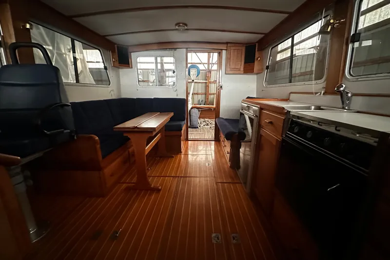 Slide: The Image of Interior of 1998 Northern Bay 36 boat with wooden flooring and seating area. - 8