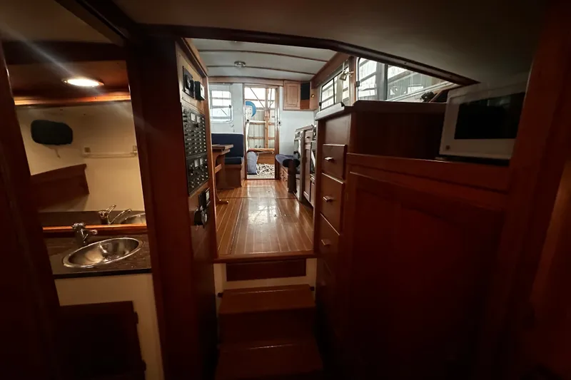 Slide: The Image of Interior of 1998 Northern Bay 36 boat with wooden cabinetry and compact kitchen area. - 9