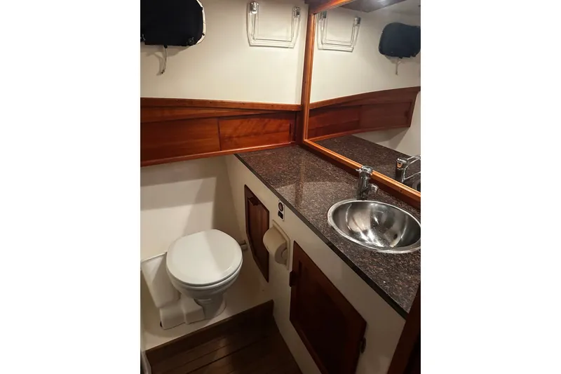 Slide: The Image of Bathroom interior of 1998 Northern Bay 36 boat with wooden accents and stainless steel sink. - 38