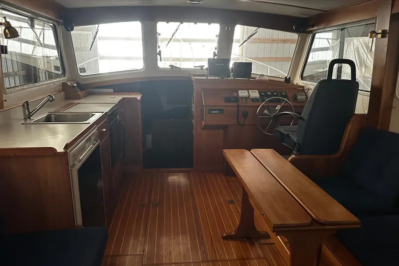Slide: The Image of Interior of 1998 Northern Bay 36 boat with wooden flooring and helm station. - 6