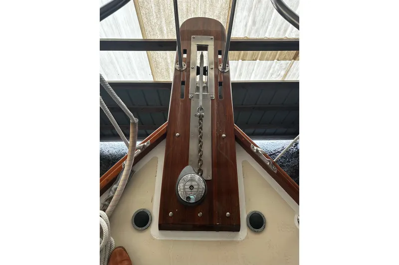 Slide: The Image of Anchor windlass on 1998 Northern Bay 36 boat deck, featuring polished wood and metal components. - 29