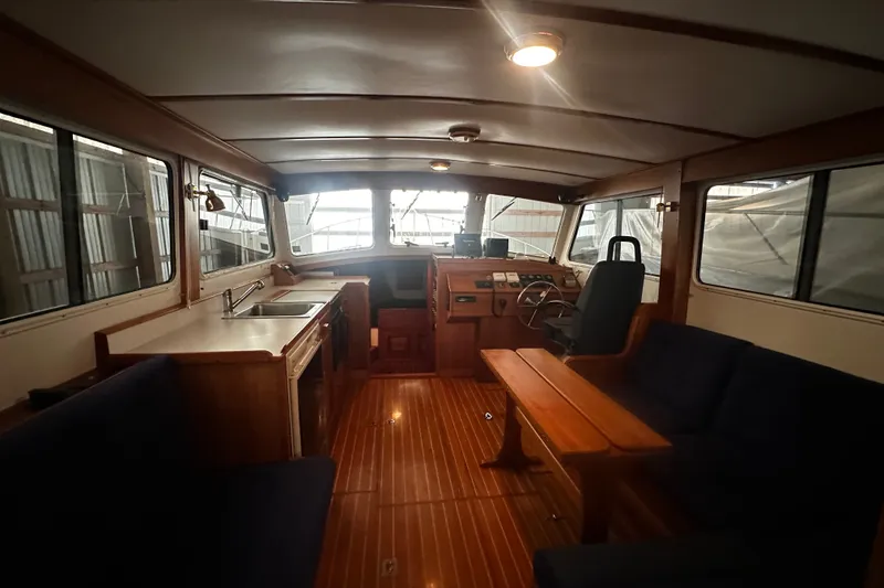 Slide: The Image of Interior of 1998 Northern Bay 36 boat with wooden furnishings and seating area. - 24
