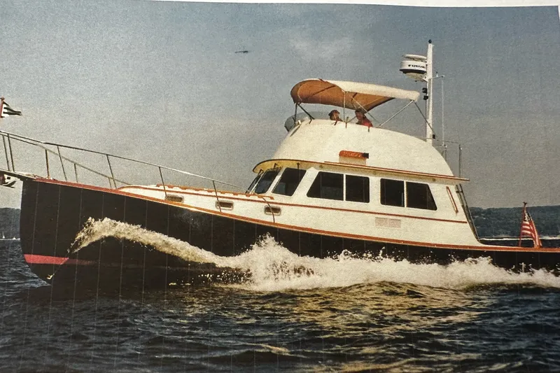 The Image of 1998 Northern Bay 36 yacht cruising on open water with passengers on deck. - 1