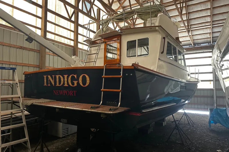 Slide: The Image of 1998 Northern Bay 36 boat named "Indigo" in a storage facility. - 5