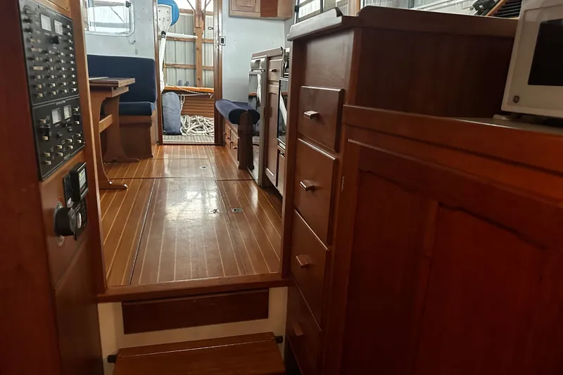 Slide: The Image of Interior of 1998 Northern Bay 36 boat with wooden cabinetry and seating area. - 10