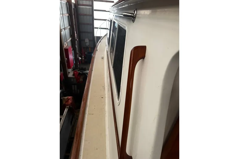 Slide: The Image of Side view of a 1998 Northern Bay 36 boat in a storage facility. - 31