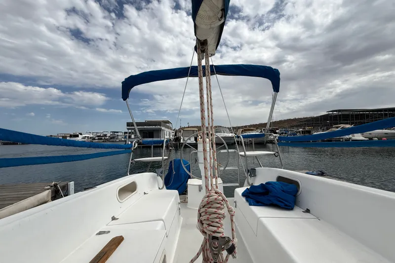 Slide: The Image of 1998 Catalina 250 sailboat docked at marina under cloudy sky. - 29