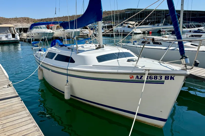 Slide: The Image of 1998 Catalina 250 sailboat docked at marina, clear blue water, sunny day. - 8