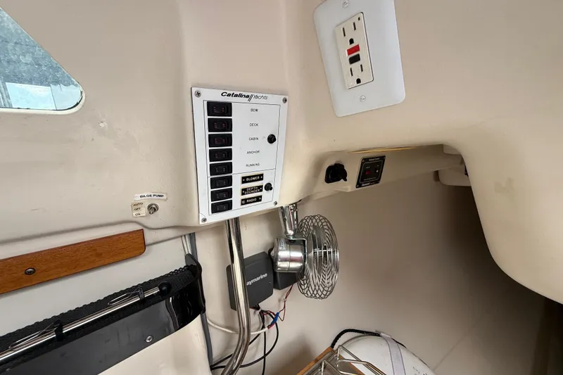 Slide: The Image of 1998 Catalina 250 yacht interior with control panel and electrical outlets. - 24