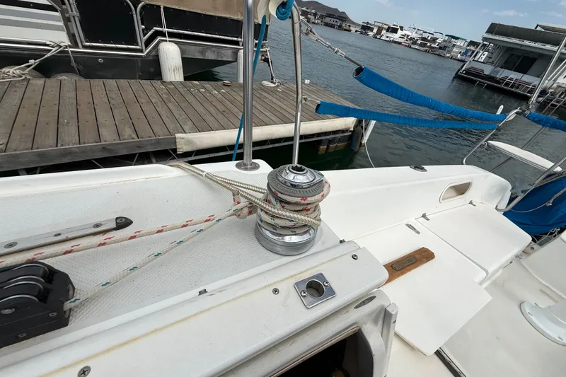 Slide: The Image of Sailboat Catalina 250, 1998 model, docked with visible winch and ropes. - 37