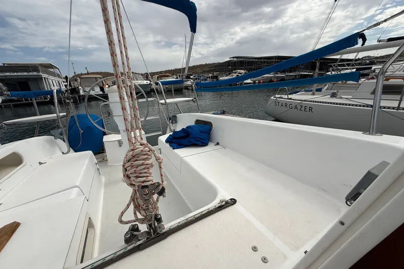 Slide: The Image of 1998 Catalina 250 sailboat docked in marina, featuring spacious cockpit and rigging. - 28