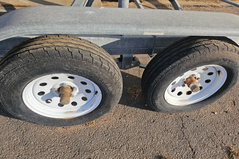 Slide: The Image of Trailer wheels on a Catalina 250, 1998 model, parked on asphalt. - 53
