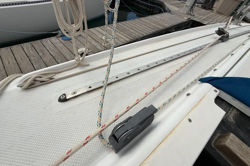 Slide: The Image of Deck of a 1998 Catalina 250 sailboat with rigging and dock in view. - 31