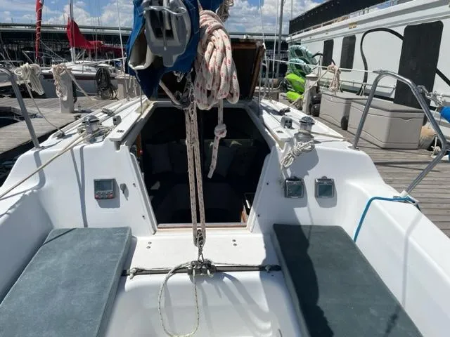 Slide: The Image of The image shows the cockpit of a 1998 Catalina 250, docked at a marina. - 4
