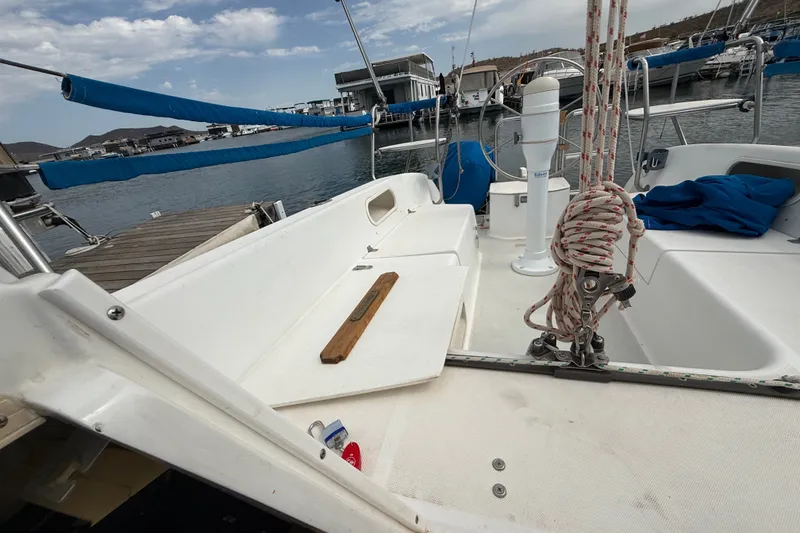 Slide: The Image of Cockpit of a 1998 Catalina 250 sailboat docked at a marina, featuring rigging and seating. - 27