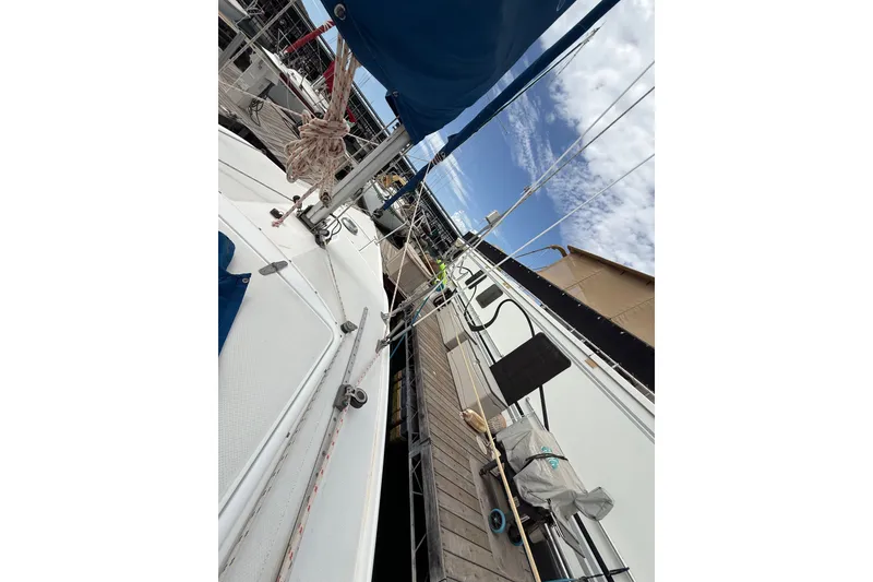 Slide: The Image of Catalina 250 sailboat docked at marina, showcasing deck and rigging, 1998 model. - 38