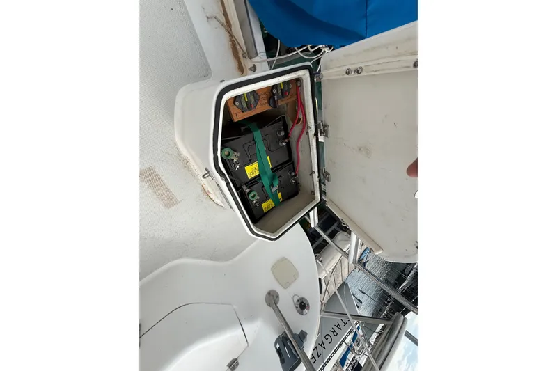 Slide: The Image of Battery compartment of a 1998 Catalina 250 sailboat, showing wiring and secure storage. - 43