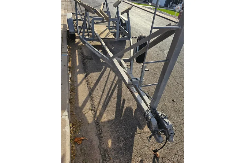 Slide: The Image of Trailer for 1998 Catalina 250 sailboat parked on street. - 52