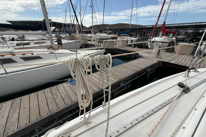 Slide: The Image of Catalina 250 sailboat docked at marina, surrounded by other boats, 1998 model. - 32