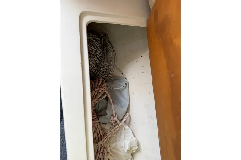 Slide: The Image of Storage compartment with ropes inside a 1998 Catalina 250 boat. - 44