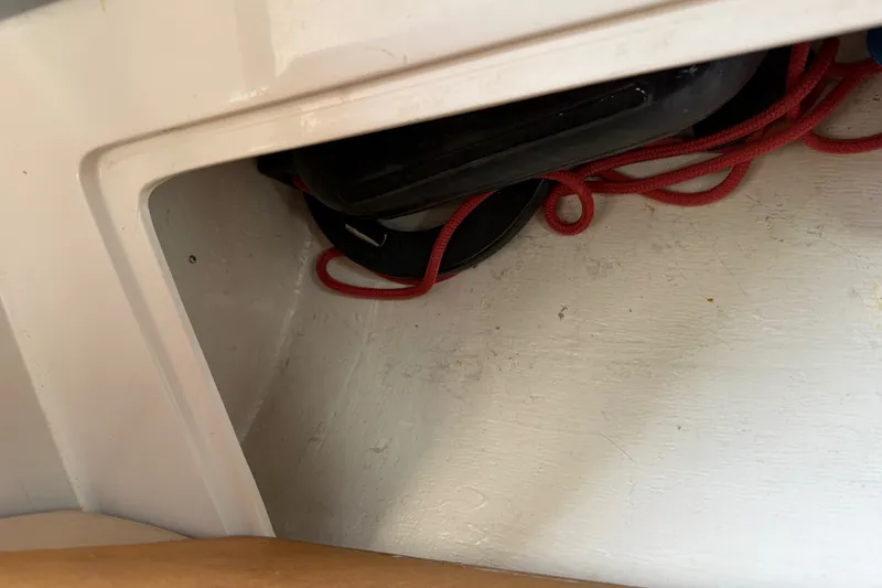 Slide: The Image of Storage compartment with red rope in a 1998 Catalina 250 boat. - 46