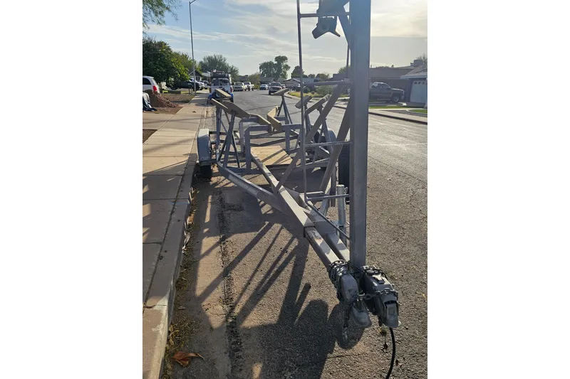 Slide: The Image of Trailer for 1998 Catalina 250 sailboat parked on a suburban street. - 51