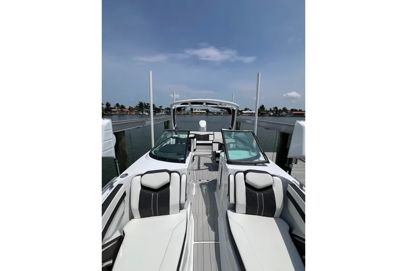 Slide: The Image of 2024 Monterey 275SS Super Sport boat docked, showcasing sleek design and luxurious seating. - 17