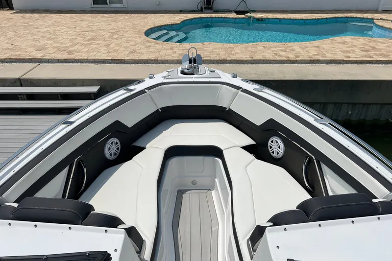 Slide: The Image of 2024 Monterey 275SS Super Sport boat interior with luxurious seating near a pool. - 11