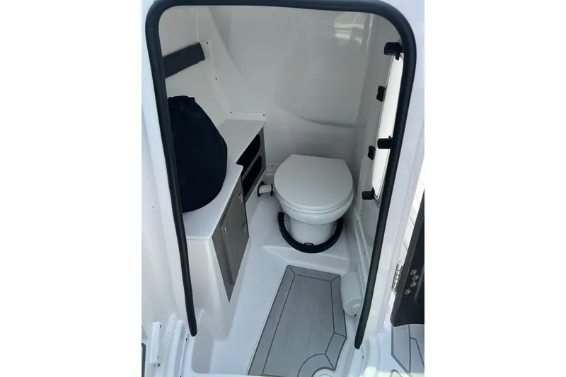 Slide: The Image of 2024 Monterey 275SS Super Sport boat interior bathroom with toilet and storage. - 33