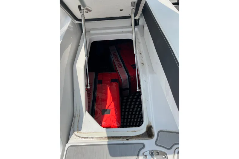 Slide: The Image of Storage compartment with life jackets in a 2024 Monterey 275SS Super Sport boat. - 51